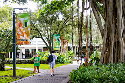 Campus near the U statue with students walking around.