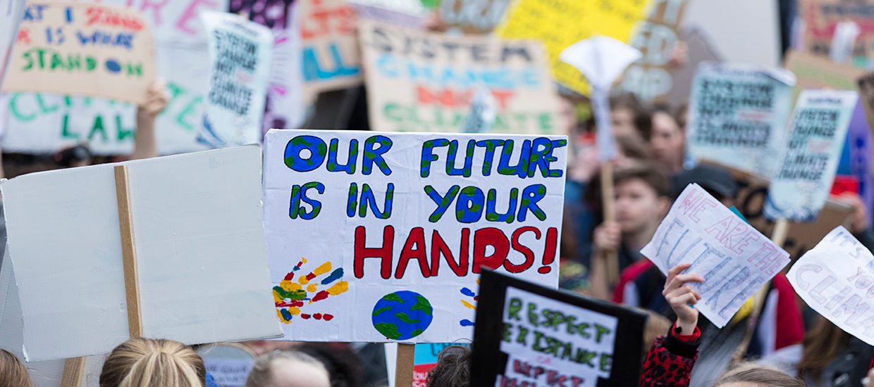 A stock photo of picket signs at a climate change protest.