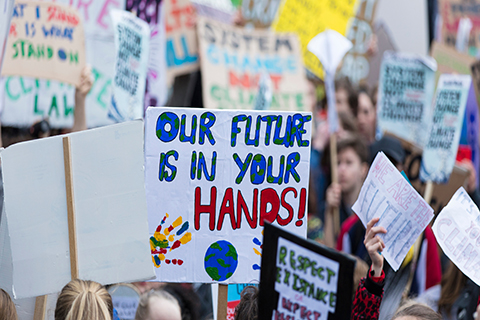 A stock photo of picket signs at a climate change protest.