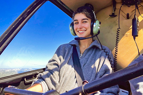 This is an image of University of Miami alumnae, Tuana Yazici. This is a photo of Tuana inside a an airplane cabin. 